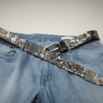 The Abstract Series Pearl Metallic Leather Belt featuring laser-etched abstract patterns hand-painted with shimmering silver-pearl pigment on premium dark leather, finished with a special alloy buckle